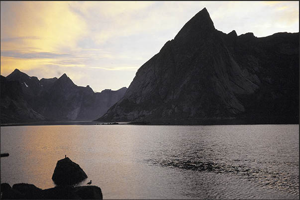 Sunset between the rocky peaks of the mountains of Moskenosoya island (Lofoten)