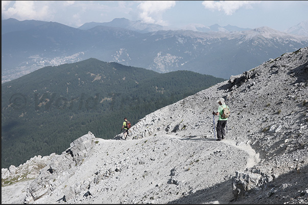 A narrow path between the rocks descends from the Orso Pass (2,481 m) towards Chateau-Beaulard (1,387 m)