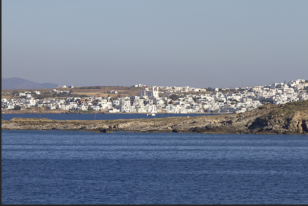 Arriving by ferry, the north coast of the island welcomes tourists with the white houses of the village of Naoussa