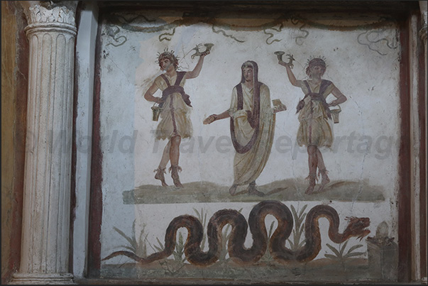 Small temple with a depiction of the guardian spirit of the house (centre) flanked by two Lares (protectors of the family)